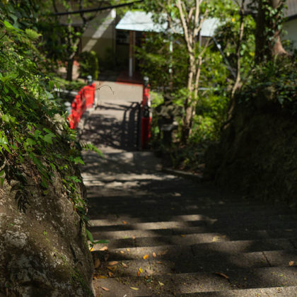 Back alley of Enoshima, stairs leading to a vermilion bridge